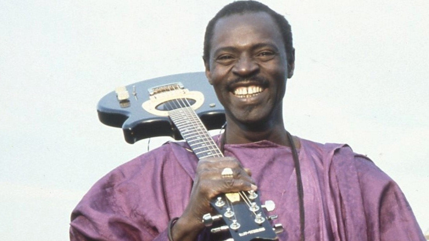 Ali Farka Toure posing with a guitar