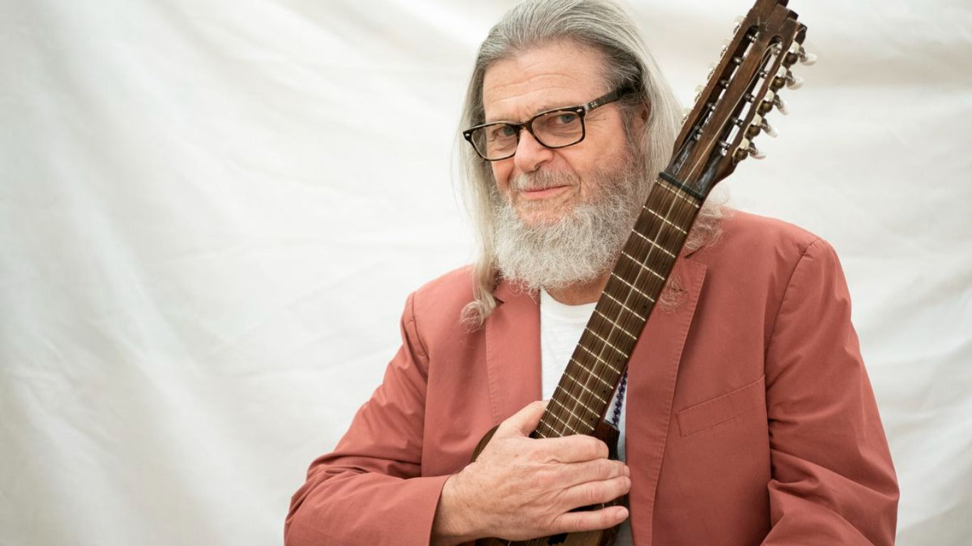 Gustavo Santolalla holding a guitar