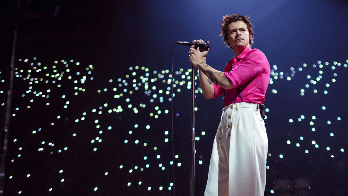 Harry Styles performing on stage in front of crowd