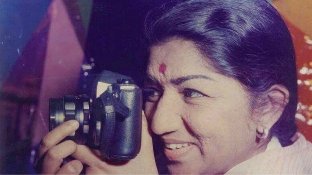 Lata Mangeshkar holding a camera
